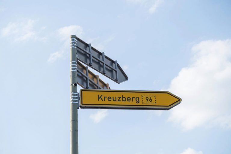 Kreuzberg signpost against blue sky, Berlin, Germany